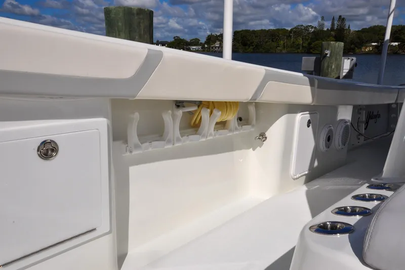 Slide: The Image of 2011 Yellowfin 39 Offshore boat interior with rod holders and storage compartments. - 36