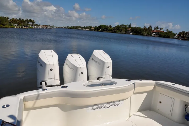 Slide: The Image of 2011 Yellowfin 39 Offshore boat with triple Mercury engines on a calm lake. - 40