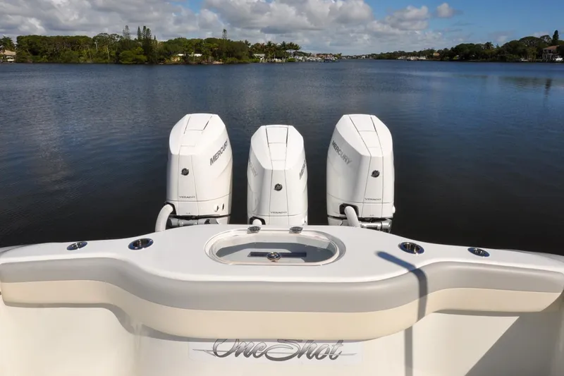 Slide: The Image of 2011 Yellowfin 39 Offshore boat with triple Mercury engines on a calm lake. - 41