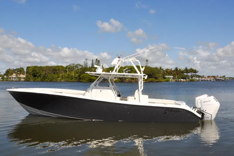 Slide: The Image of 2011 Yellowfin 39 Offshore boat on calm water, clear sky background. - 45