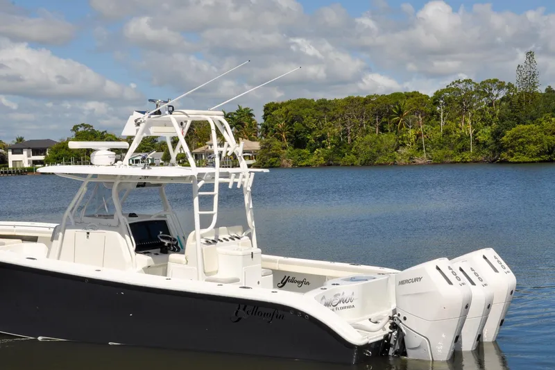 Slide: The Image of 2011 Yellowfin 39 Offshore boat with triple Mercury engines on a scenic lake. - 46