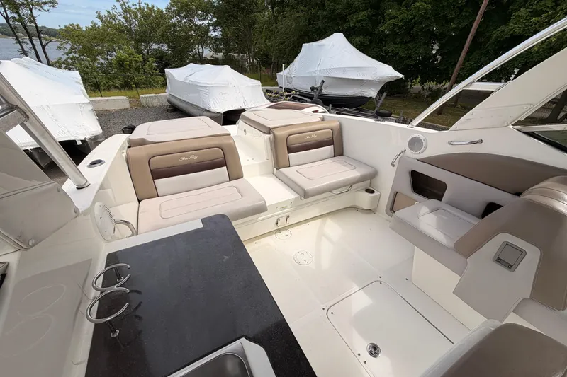 Slide: The Image of Interior of a 2011 Sea Ray 300 SLX boat with beige seating and sleek design. - 10