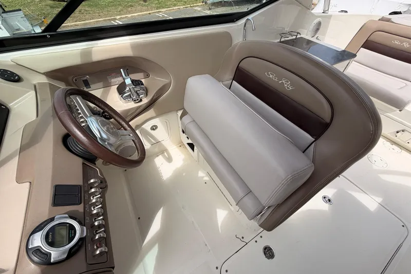 Slide: The Image of Interior of a 2011 Sea Ray 300 SLX boat, featuring steering wheel and controls. - 13