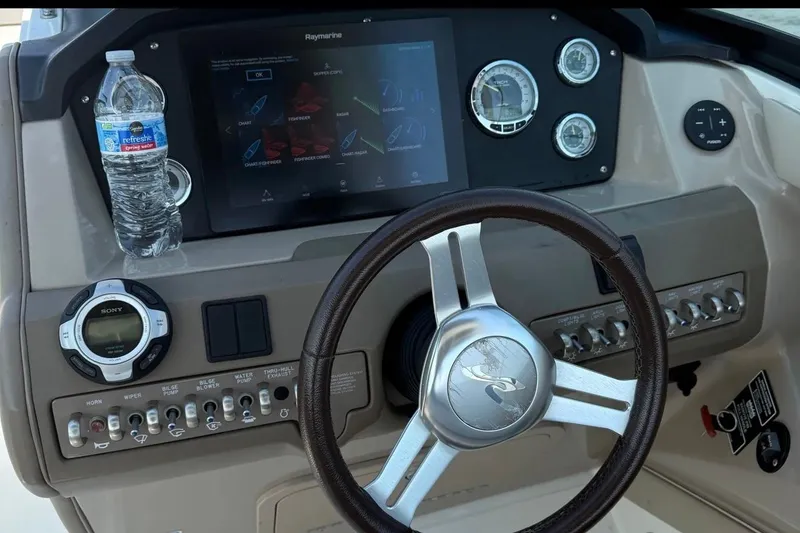 Slide: The Image of Steering console of a 2011 Sea Ray 300 SLX boat with navigation controls. - 14