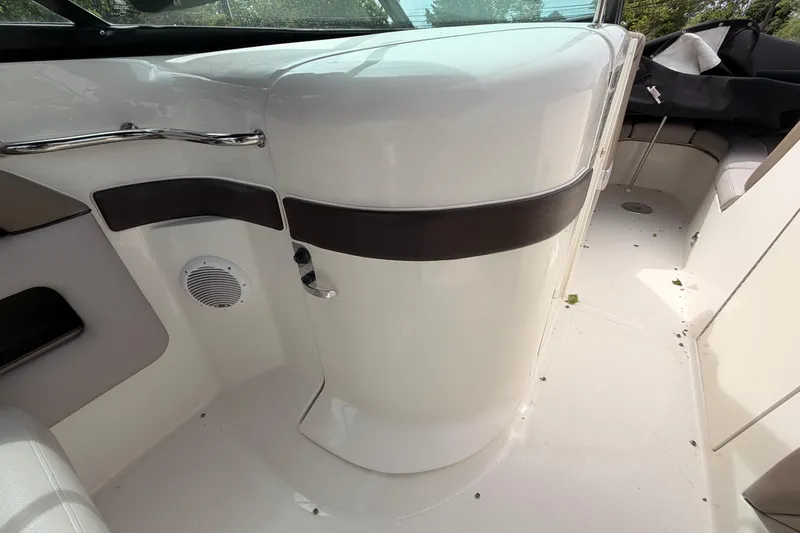 Slide: The Image of Interior view of a 2011 Sea Ray 300 SLX boat, featuring sleek white and brown design. - 17