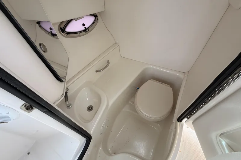 Slide: The Image of 2011 Sea Ray 300 SLX boat bathroom with toilet and sink. - 18