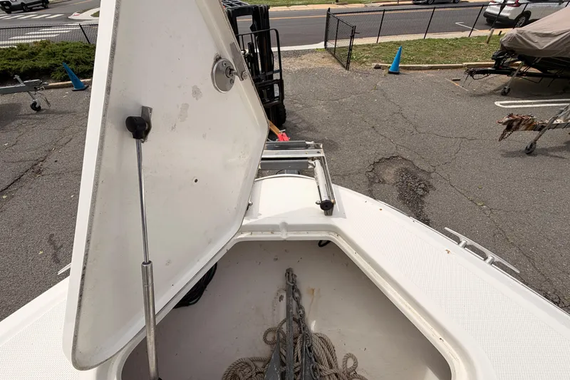 Slide: The Image of Open anchor compartment on a 2011 Sea Ray 300 SLX boat in a parking area. - 20