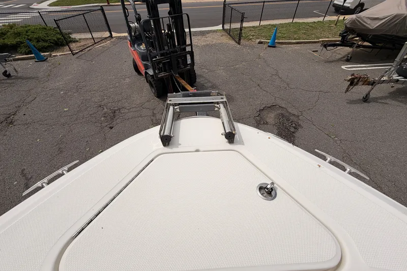 Slide: The Image of 2011 Sea Ray 300 SLX boat on trailer with forklift in parking lot. - 21
