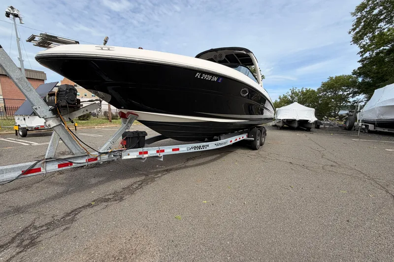 Slide: The Image of 2011 Sea Ray 300 SLX boat on trailer in parking lot, ready for transport. - 3