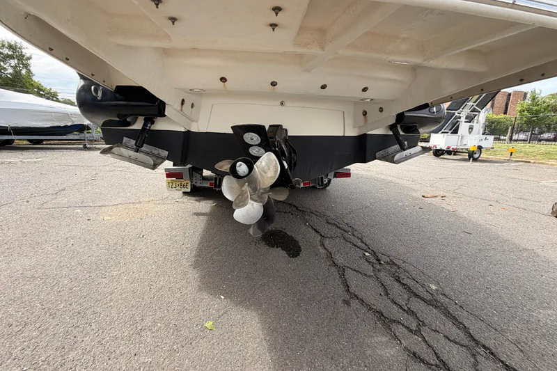 Slide: The Image of Rear view of a 2011 Sea Ray 300 SLX boat on a trailer, showing propellers and trim tabs. - 6