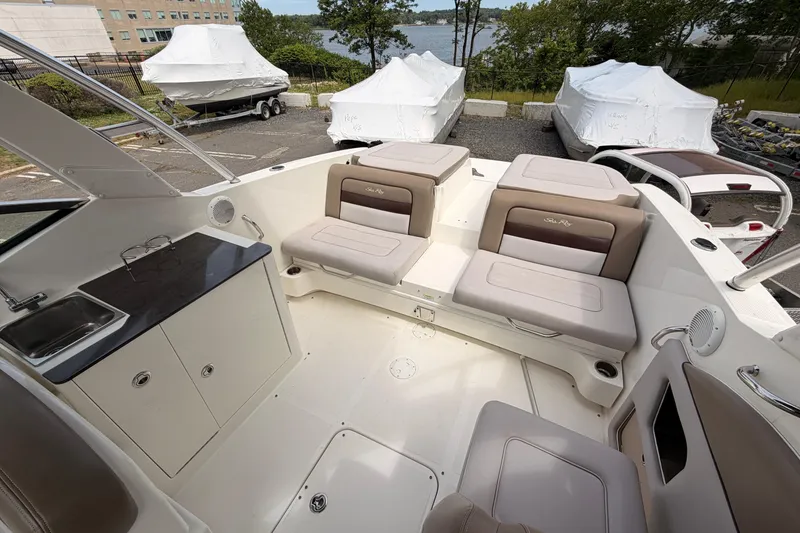 Slide: The Image of Interior of a 2011 Sea Ray 300 SLX boat with seating and kitchenette. - 9