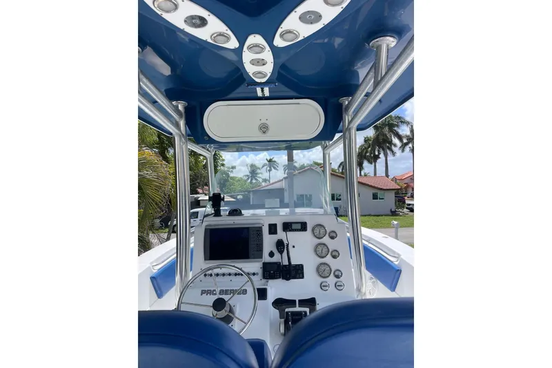Slide: The Image of 2009 Sea Fox 288 Commander boat dashboard with steering wheel and navigation instruments. - 11