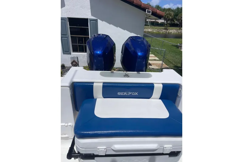 Slide: The Image of 2009 Sea Fox 288 Commander boat with dual blue outboard motors and cushioned seating. - 14
