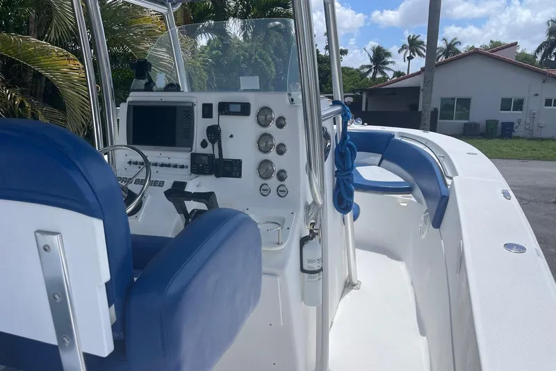 Slide: The Image of 2009 Sea Fox 288 Commander boat interior with blue seating and control panel. - 15