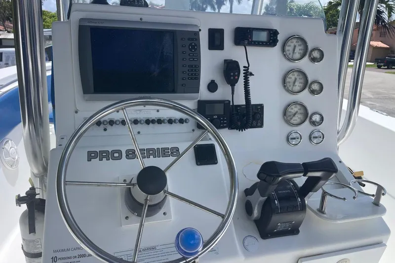 Slide: The Image of Control panel of a 2009 Sea Fox 288 Commander boat with steering wheel and gauges. - 19