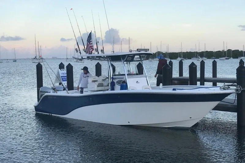Slide: The Image of 2009 Sea Fox 288 Commander boat docked at marina with fishing rods and American flag. - 3