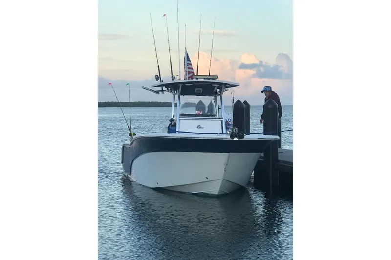 Slide: The Image of 2009 Sea Fox 288 Commander boat docked at sunset with fishing rods and flags. - 4
