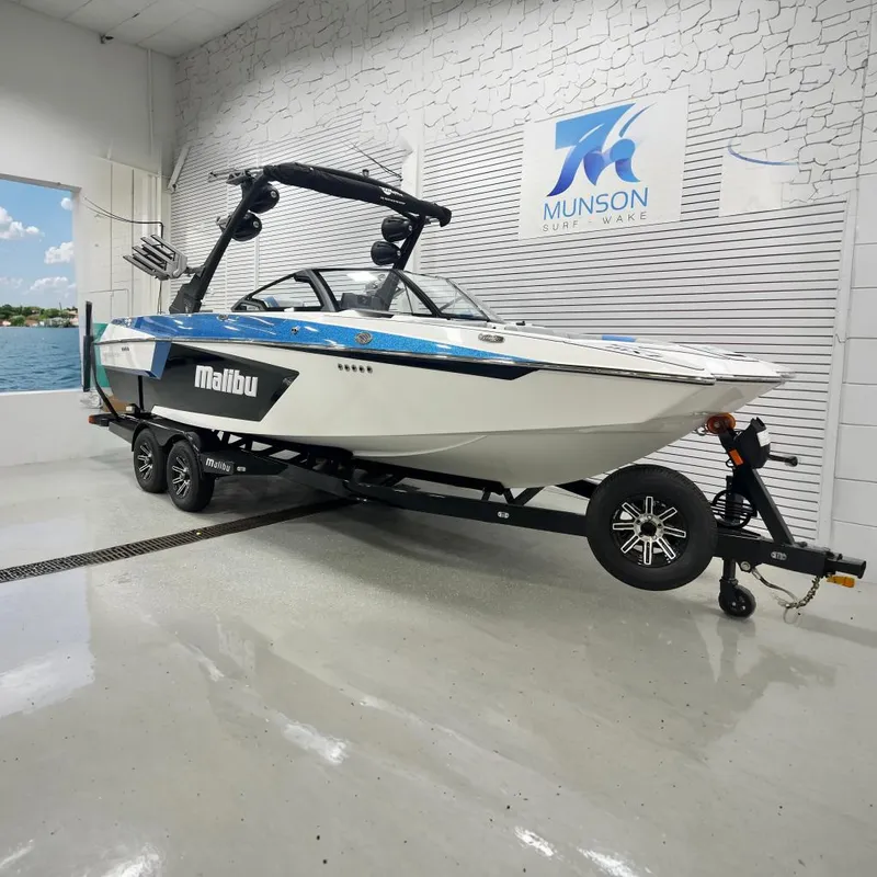 The Image of 2024 Malibu Wakesetter 24 MXZ boat on trailer in showroom. - 0