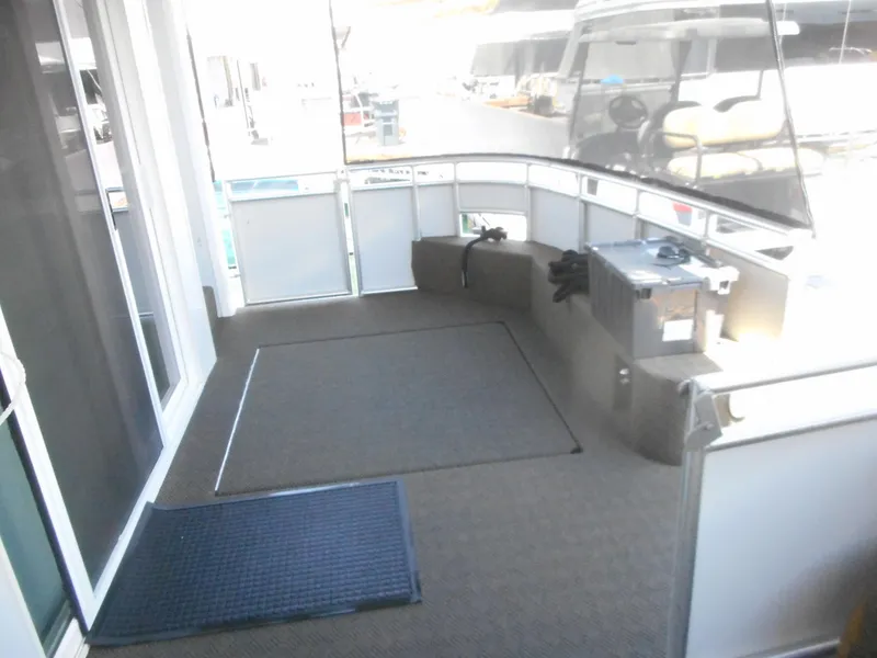 Slide: The Image of Spacious deck area on 2021 Adonia Obsession Trip #12 houseboat, featuring seating and carpeted flooring. - 2