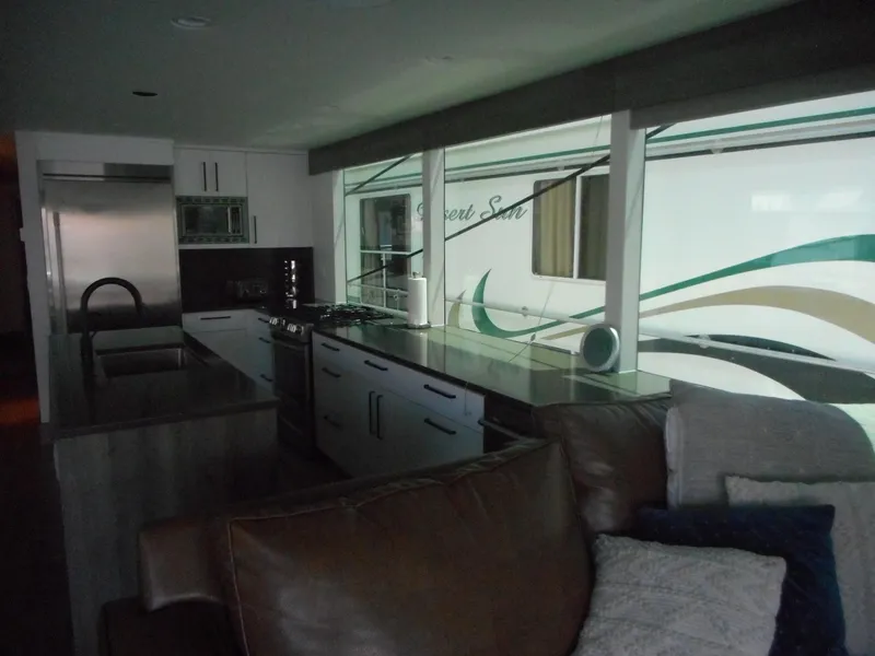 Slide: The Image of Modern RV interior with kitchen, featuring sleek countertops and appliances. Adonia Obsession Trip #12, 2021. - 22