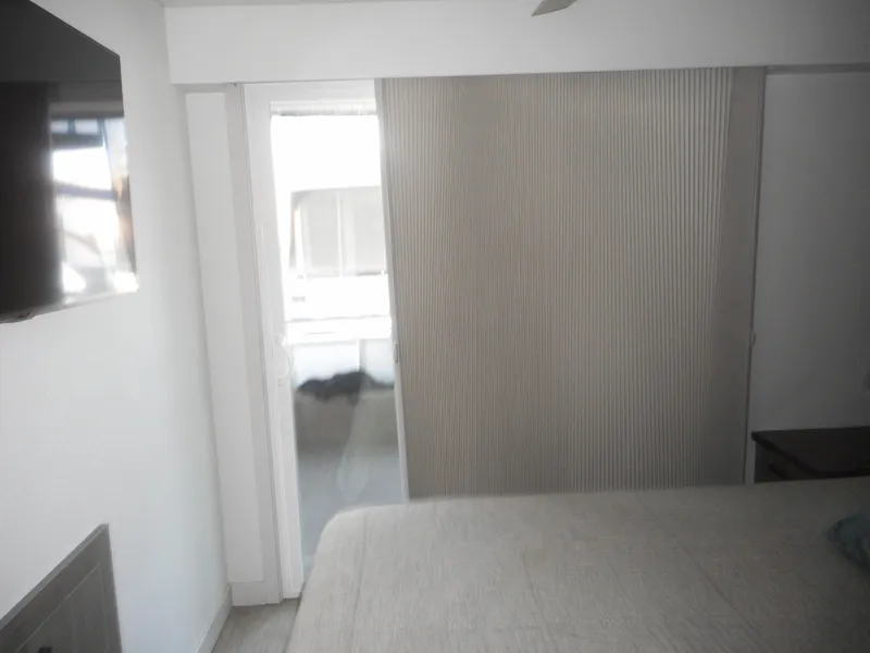 Slide: The Image of Modern bedroom with sliding door, wall-mounted TV, and neutral decor. Adonia Obsession Trip #12, 2021. - 6