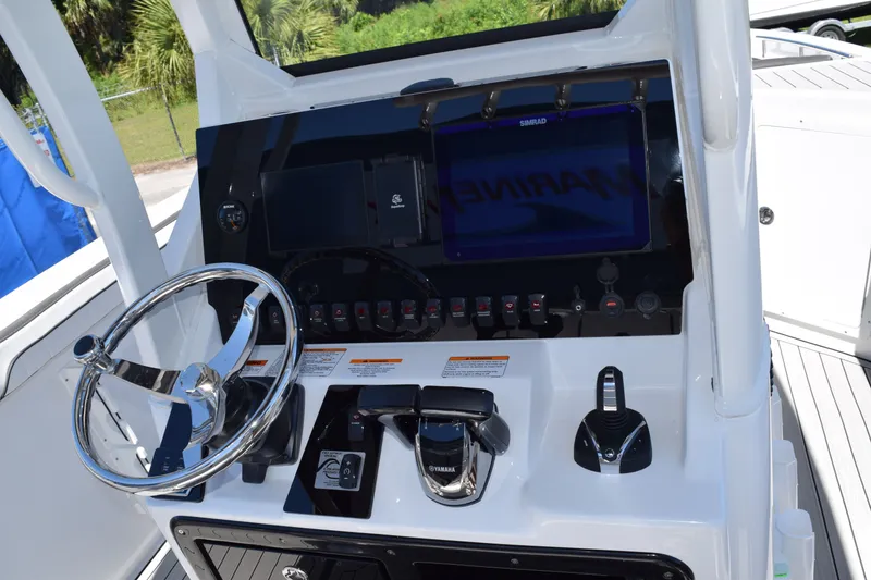 Slide: The Image of Yamaha Boats 255 FSH Sport H 2026 helm with steering wheel and controls. - 17