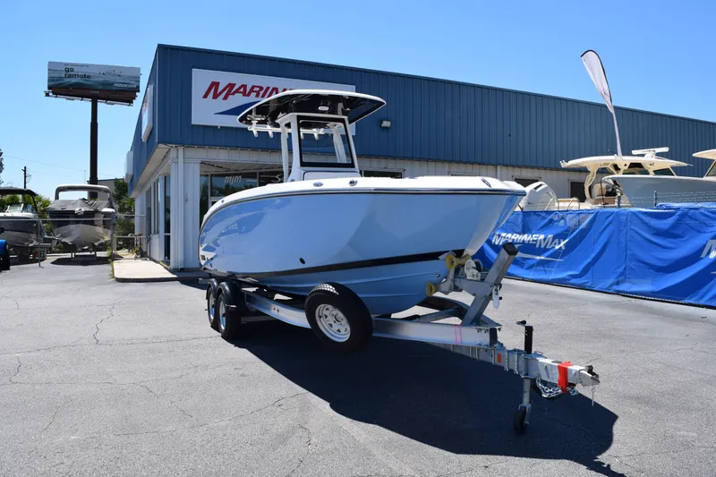 Slide: The Image of 2026 Yamaha Boats 255 FSH Sport H in front of a marine store. - 2