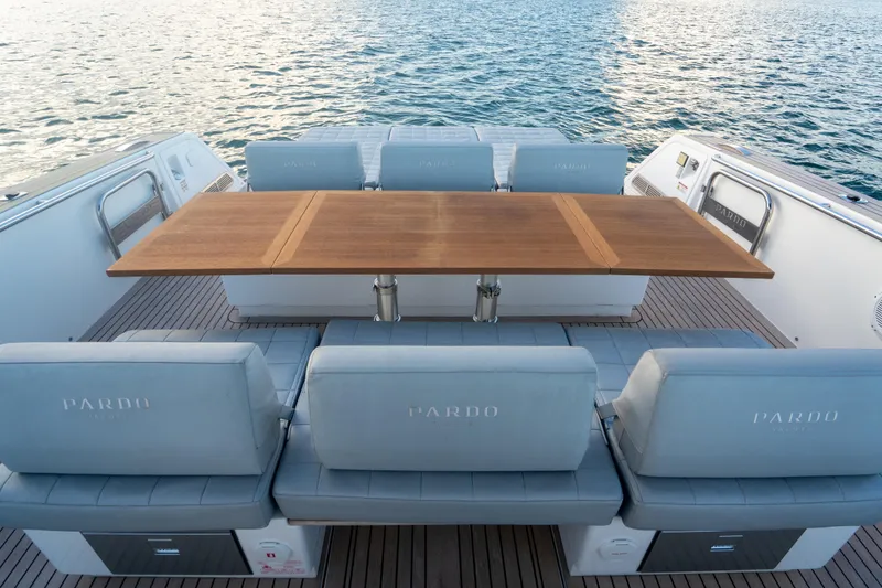 Slide: The Image of Luxury seating area on 2021 Pardo Yachts 43, featuring elegant wooden table. - 14