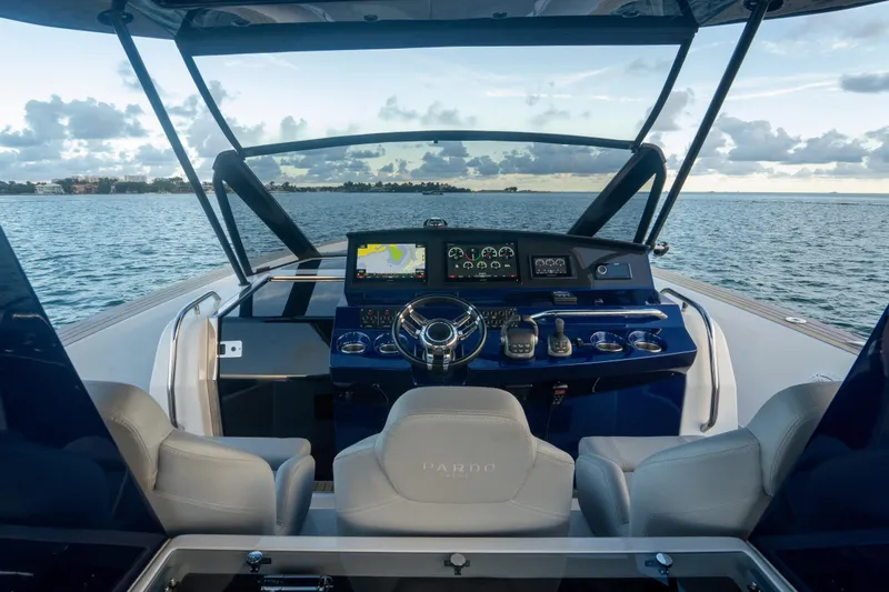 Slide: The Image of Helm of 2021 Pardo Yachts 43 with modern navigation equipment, overlooking serene waters. - 18