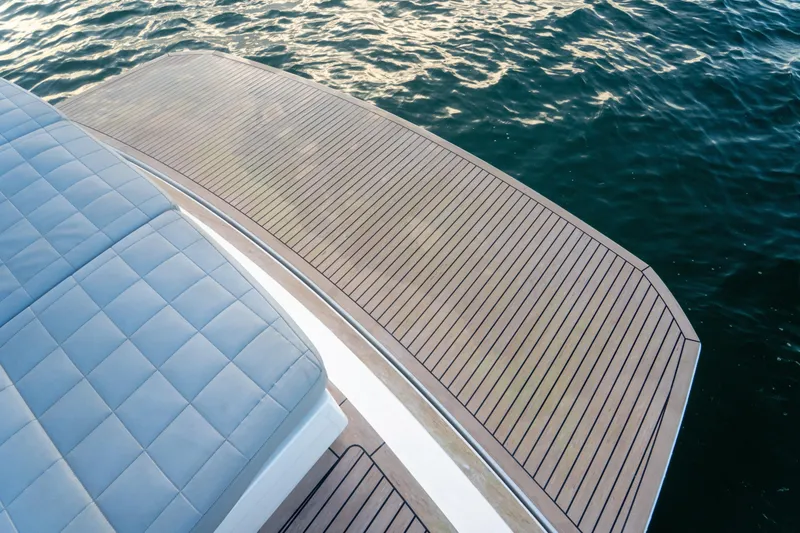 Slide: The Image of Luxury Pardo Yachts 43 (2021) deck with cushioned seating, overlooking serene water. - 9