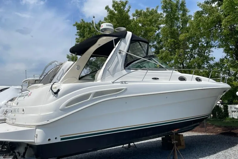 Slide: The Image of 2000 Sea Ray 340 Sundancer boat on display, surrounded by trees and sky. - 3
