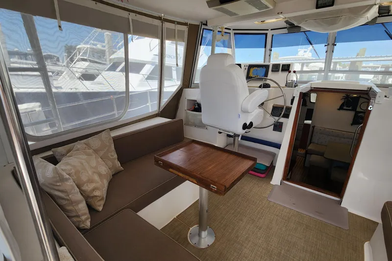 Slide: The Image of Interior of 2003 Endeavour 44 TrawlerCat with helm, seating, and table. - 10
