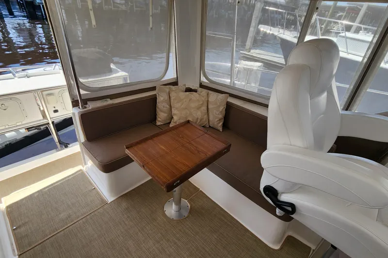 Slide: The Image of Interior of 2003 Endeavour 44 TrawlerCat with seating and wooden table. - 14