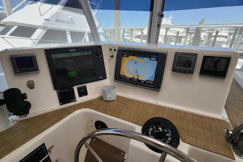 Slide: The Image of Helm of 2003 Endeavour 44 TrawlerCat with navigation displays and steering wheel. - 17