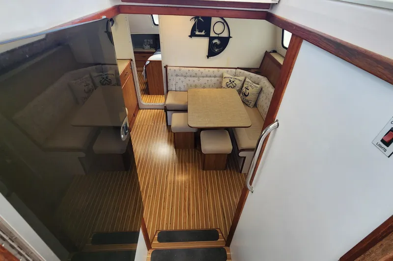 Slide: The Image of Interior of 2003 Endeavour 44 TrawlerCat with cozy dining area and nautical decor. - 18