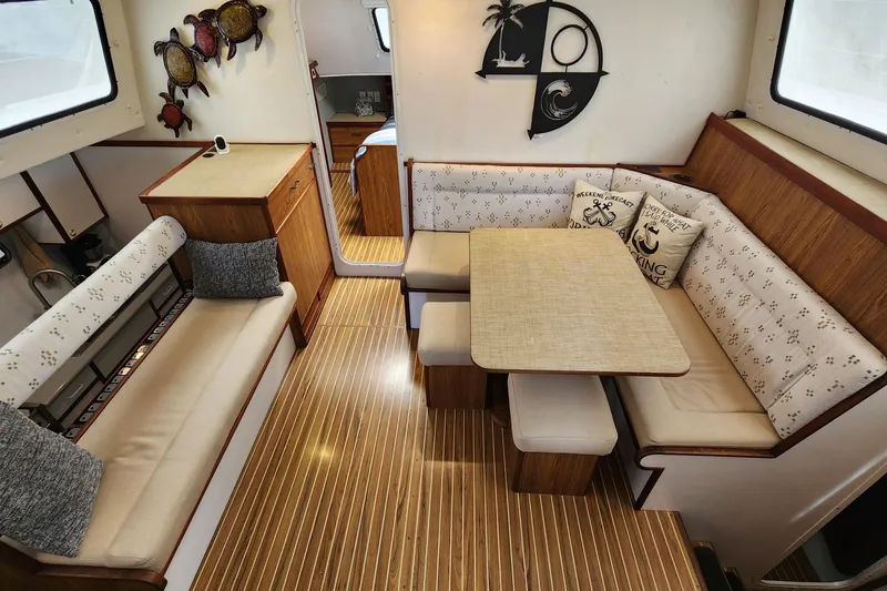 Slide: The Image of Interior of 2003 Endeavour 44 TrawlerCat with cozy seating and nautical decor. - 19