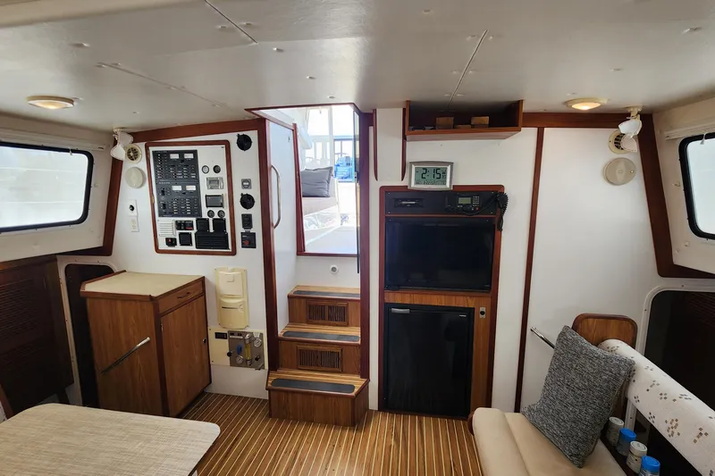Slide: The Image of Interior of 2003 Endeavour 44 TrawlerCat with control panel, seating, and wooden accents. - 22