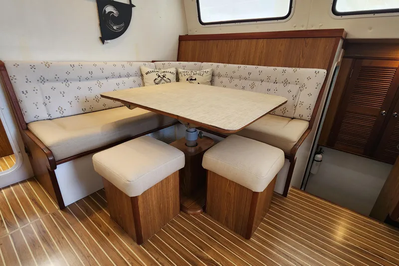 Slide: The Image of Interior of 2003 Endeavour 44 TrawlerCat with cozy dining area and wooden flooring. - 24