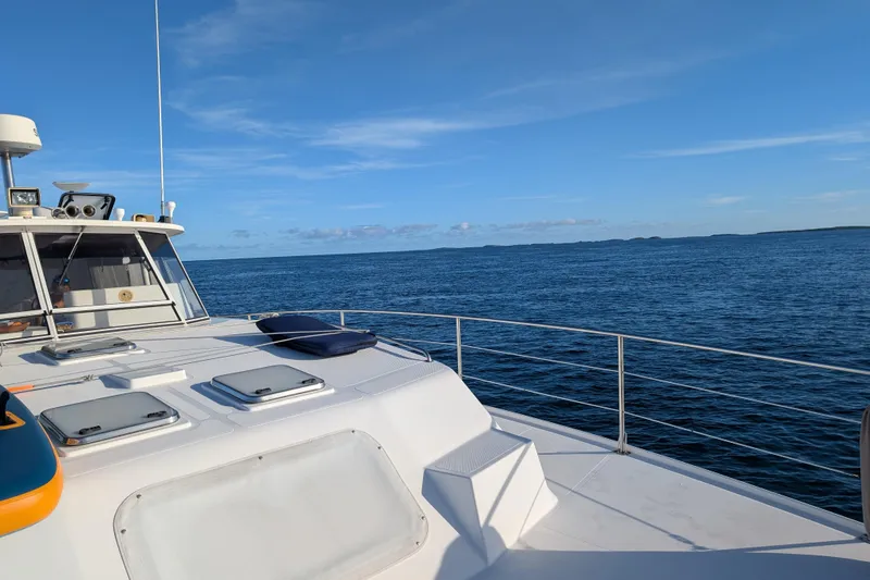 Slide: The Image of 2003 Endeavour 44 TrawlerCat cruising on open sea under clear blue sky. - 3