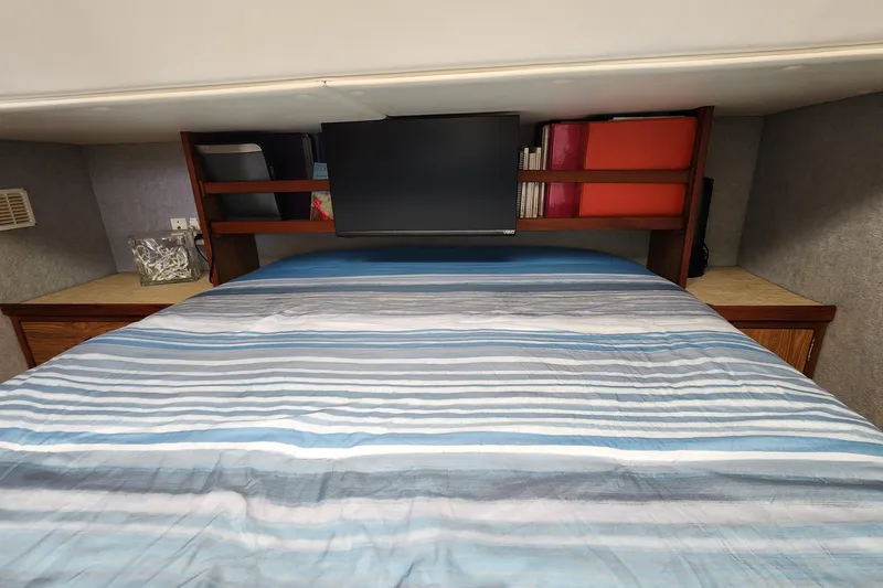 Slide: The Image of Cozy cabin bedroom in 2003 Endeavour 44 TrawlerCat with striped bedding and TV. - 30