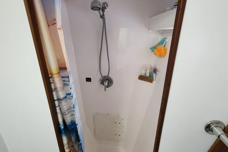 Slide: The Image of Shower area in 2003 Endeavour 44 TrawlerCat with curtain and toiletries. - 32