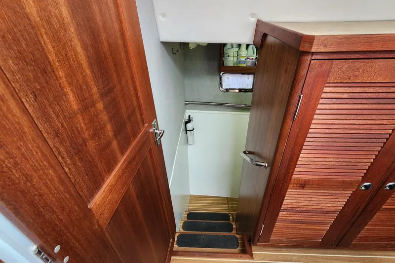 Slide: The Image of Interior view of 2003 Endeavour 44 TrawlerCat, featuring wooden cabinetry and stairs. - 33