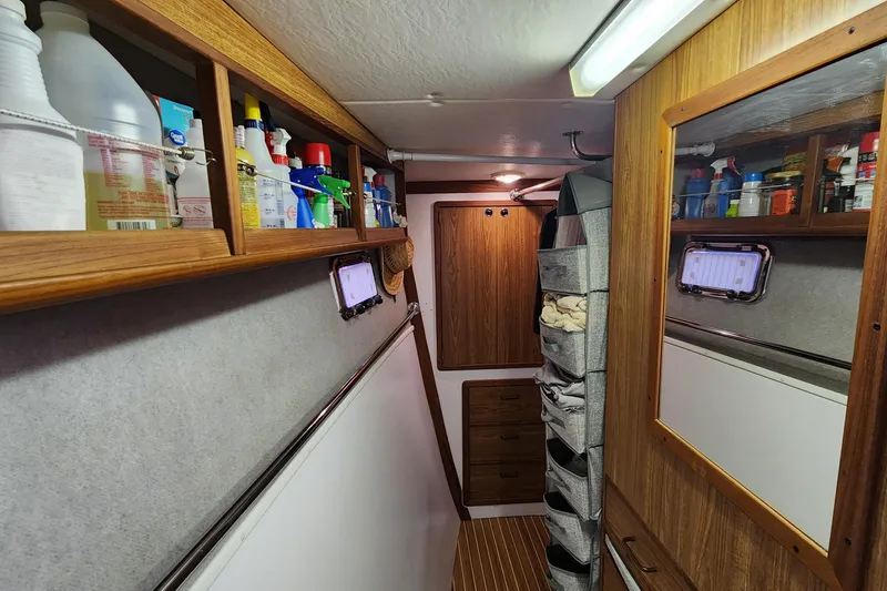 Slide: The Image of Interior of 2003 Endeavour 44 TrawlerCat with storage shelves and cleaning supplies. - 34