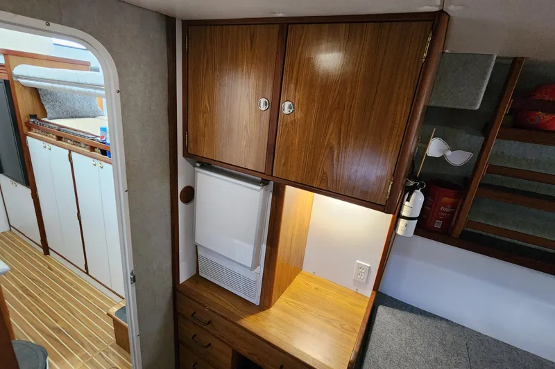 Slide: The Image of Interior of 2003 Endeavour 44 TrawlerCat with wooden cabinets and cozy sleeping area. - 40