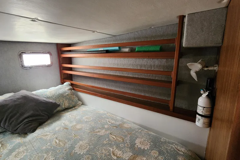 Slide: The Image of Cozy cabin interior of 2003 Endeavour 44 TrawlerCat with bed, window, and storage shelves. - 41