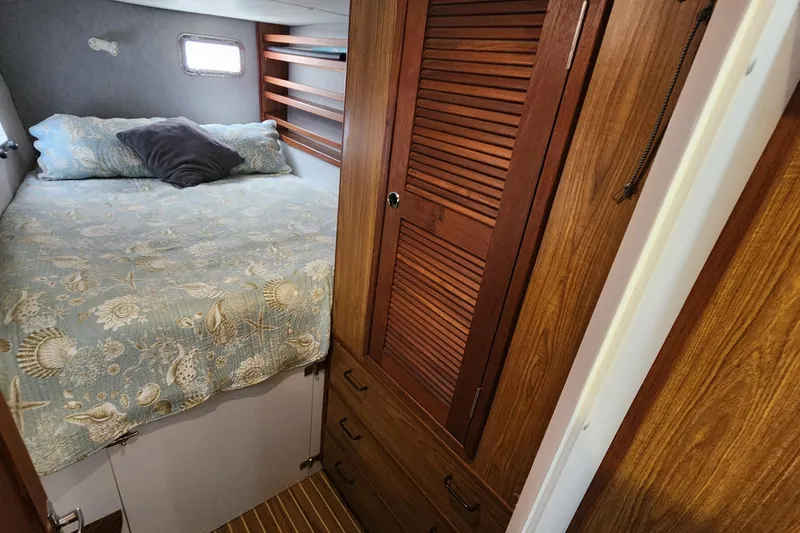 Slide: The Image of Cozy cabin interior of 2003 Endeavour 44 TrawlerCat with bed and wooden storage. - 42