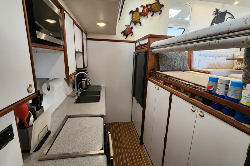 Slide: The Image of 2003 Endeavour 44 TrawlerCat kitchen with modern appliances and cozy seating area. - 55