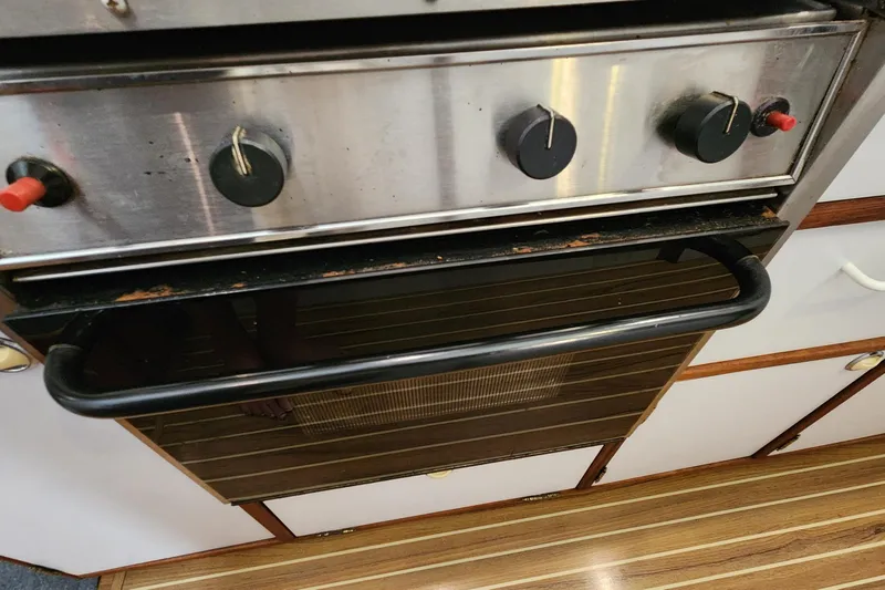 Slide: The Image of Stainless steel oven with black knobs in 2003 Endeavour 44 TrawlerCat kitchen. - 57
