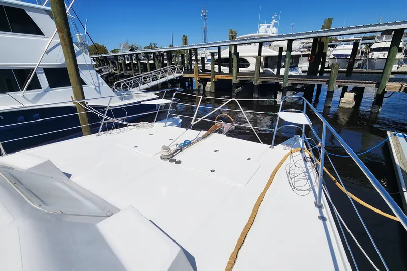 Slide: The Image of 2003 Endeavour 44 TrawlerCat docked at marina, showcasing spacious deck and railing. - 60