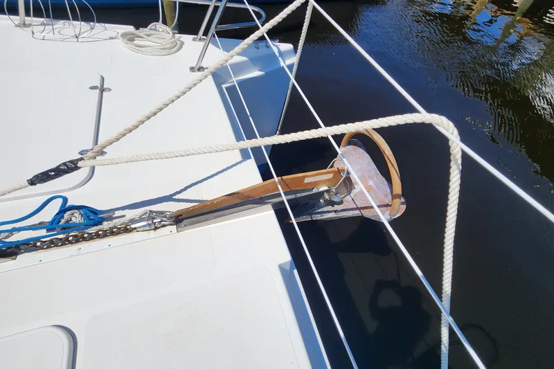 Slide: The Image of Anchor and ropes on 2003 Endeavour 44 TrawlerCat, docked on calm water. - 61